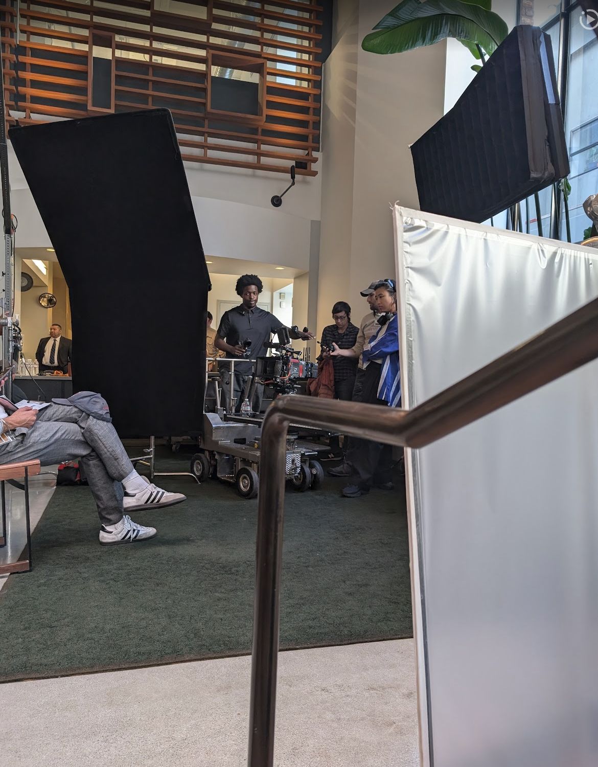 A film set with camera dolly, flags, and crew between setups